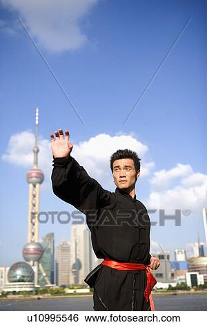 Young man doing martial arts on the Bund View Large Photo Image Stock Photograph - Young man doing martial arts on the Bund. Fotosearch