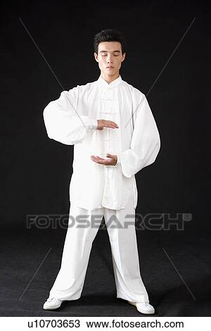 Stock Image - Young man in martial arts pose in studio shot. Fotosearch