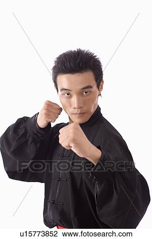 Stock Image - Young man in martial arts pose in studio shot. Fotosearch