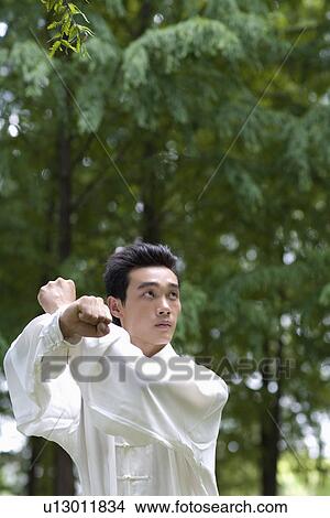 Young man in martial arts pose View Large Photo Image Picture - Young man in martial arts pose. Fotosearch