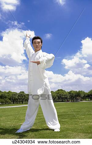 Picture - Young man in martial arts pose. Fotosearch