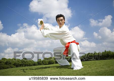 Stock Photo - Young man posing in a martial arts position. Fotosearch