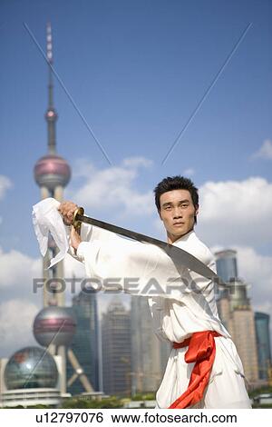 Young man practicing martial arts with swords View Large Photo Image Stock Photograph - Young man practicing martial arts with swords. Fotosearch