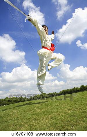 Stock Photo - Young man practicing wushu. Fotosearch
