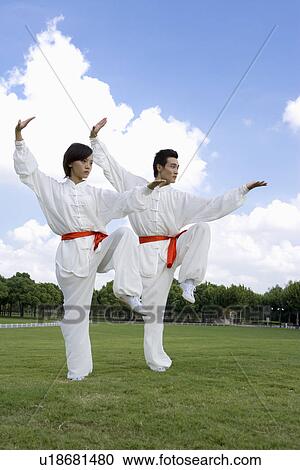Young woman and man doing kung-fu moves on lawn View Large Photo Image Stock Image - Young woman and man doing kung-fu moves on lawn. Fotosearch