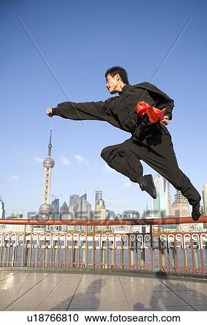Young woman doing kung-fu moves in mid air View Large Photo Image Stock Image - Young woman doing kung-fu moves in mid air. Fotosearch