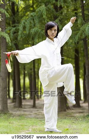 Young woman in martial arts pose View Large Photo Image Stock Photo - Young woman in martial arts pose. Fotosearch