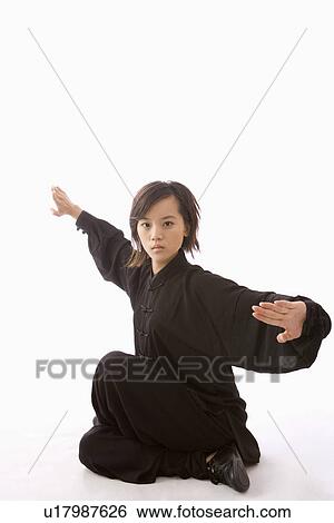 Stock Photograph - Young woman in martial arts pose. Fotosearch