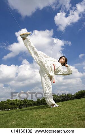 Young woman performing martial arts kick View Large Photo Image Stock Image - Young woman performing martial arts kick. Fotosearch
