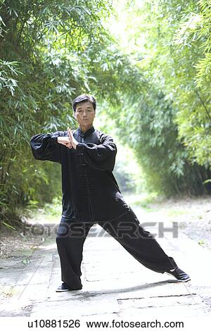 Man doing Tai Chi in bamboo grove View Large Photo Image Stock Photograph - Man doing Tai Chi in bamboo grove. Fotosearch
