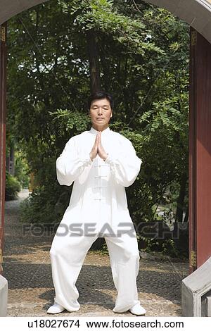 Picture - Man doing Tai Chi in Longhua temple. Fotosearch