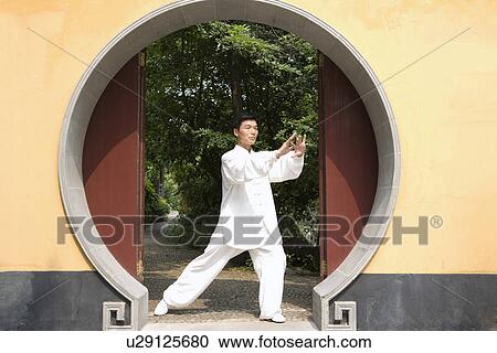 Man doing Tai Chi in LongHua temple View Large Photo Image Stock Image - Man doing Tai Chi in LongHua temple. Fotosearch
