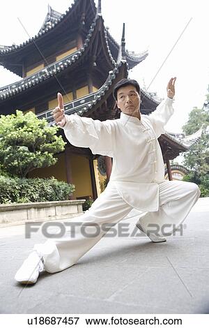 Stock Photo - Man doing Tai Chi in LongHua temple. Fotosearch