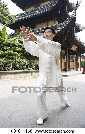 Man doing Tai Chi in Longhua temple View Large Photo Image Stock Photo - Man doing Tai Chi in Longhua temple. Fotosearch