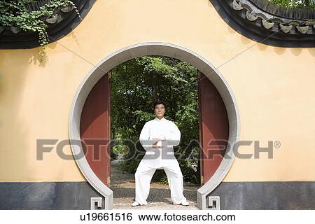 Stock Photograph - Man doing Tai Chi in Longhua temple. Fotosearch