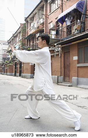 Man doing Tai Chi in Shiku Gate View Large Photo Image Stock Image - Man doing Tai Chi in Shiku Gate. Fotosearch