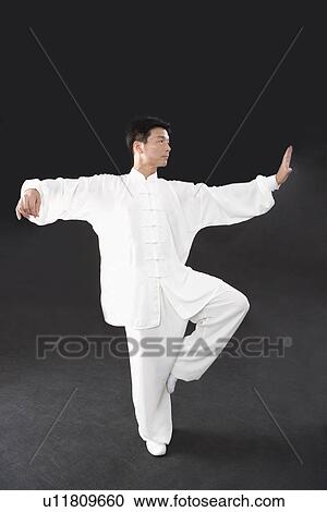 Stock Image - Man doing Tai Chi in studio shot. Fotosearch