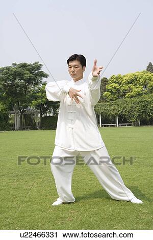 Man doing Tai Chi on lawn View Large Photo Image Stock Image - Man doing Tai Chi on lawn. Fotosearch