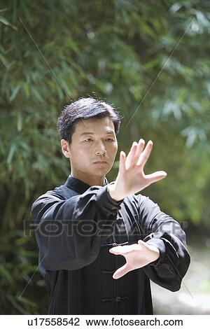 Stock Image - Man doing Tai Chi Outdoors. Fotosearch