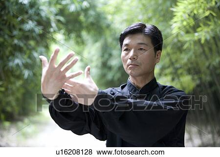 Stock Photo - Man doing Tai Chi Outdoors. Fotosearch
