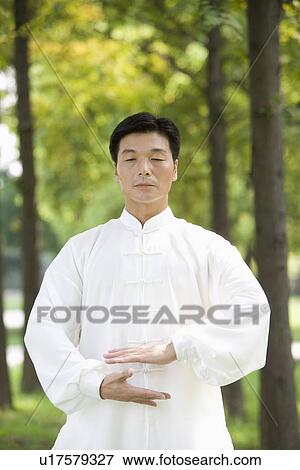 Stock Photo - Man doing Tai Chi Outdoors. Fotosearch
