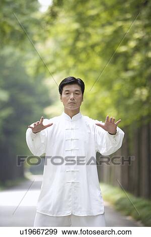 Stock Photo - Man doing Tai Chi Outdoors. Fotosearch