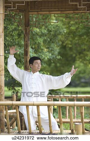 Man practicing Tai Chi in bamboo pavilion View Large Photo Image Stock Image - Man practicing Tai Chi in bamboo pavilion. Fotosearch