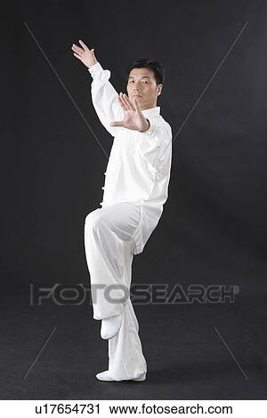 Man practicing Tai Chi in black background View Large Photo Image Stock Image - Man practicing Tai Chi in black background. Fotosearch