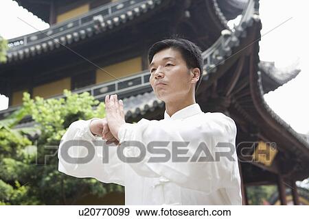 Man practicing Tai Chi in front of LongHua temple View Large Photo Image Stock Photo - Man practicing Tai Chi in front of LongHua temple. Fotosearch