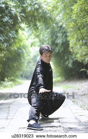 Man practicing Tai Chi on footpath View Large Photo Image Stock Image - Man practicing Tai Chi on footpath. Fotosearch