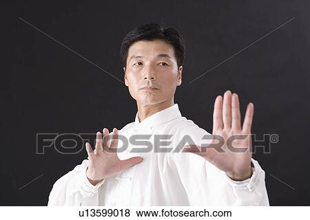 Stock Photo - Man practicing Tai Chi. Fotosearch