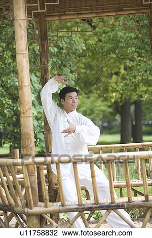 Mature man practicing Tai Chi in bamboo pavilion View Large Photo Image Stock Image - Mature man practicing Tai Chi in bamboo pavilion. Fotosearch
