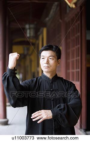 Mature man practicing Tai Chi in corridor in Longhua temple View Large Photo Image Stock Image - Mature man practicing Tai Chi in corridor in Longhua temple. Fotosearch