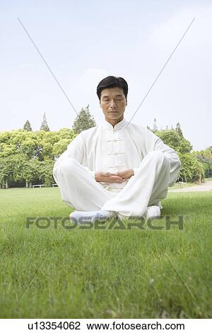 Mature man practicing Tai Chi on lawn View Large Photo Image Stock Image - Mature man practicing Tai Chi on lawn. Fotosearch