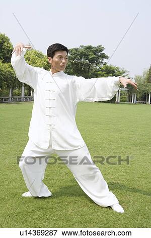Mature man practicing Tai Chi on lawn View Large Photo Image Stock Photo - Mature man practicing Tai Chi on lawn. Fotosearch