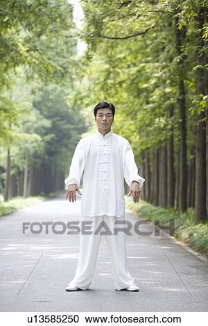 Mature man practicing Tai Chi on treelined footpath View Large Photo Image Stock Image - Mature man practicing Tai Chi on treelined footpath. Fotosearch