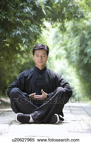 Mature man sitting on ground practicing Tai Chi View Large Photo Image Stock Photography - Mature man sitting on ground practicing Tai Chi. Fotosearch