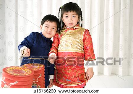 Boy and girl in Chinese traditional clothes with lantern standing and laughing View Large Photo Image Stock Image - Boy and girl in Chinese traditional clothes with lantern standing and laughing. Fotosearch