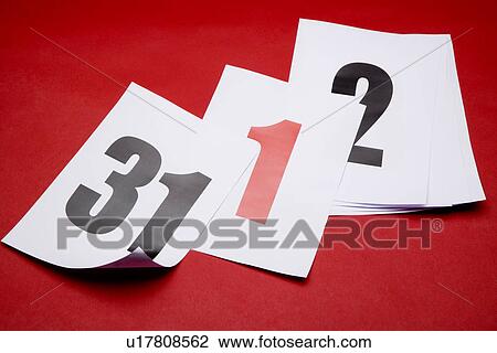 Stock Image - Calendar papers with red background. Fotosearch
