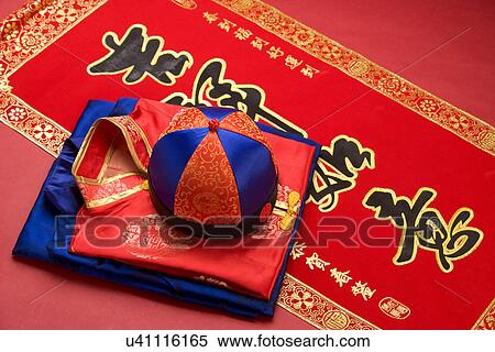 Stock Photography - Chinese traditional cap and clothes on couplet. Fotosearch