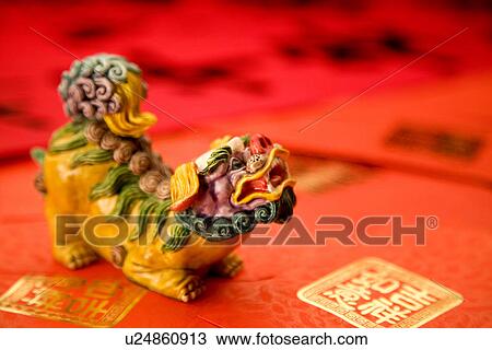 Stock Image - Colored China lion on red envelopes. Fotosearch