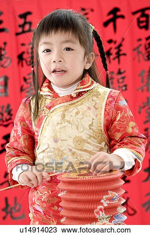 Girl in Chinese traditional clothes with lantern standing View Large Photo Image Stock Image - Girl in Chinese traditional clothes with lantern standing. Fotosearch