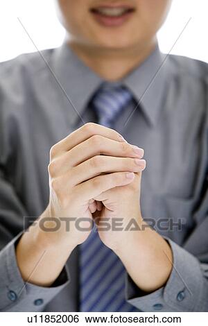 Man with hands clasped toward to camera View Large Photo Image Stock Photograph - Man with hands clasped toward to camera. Fotosearch