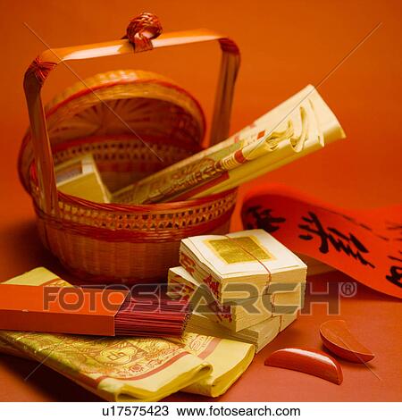 Stock Image - Wicker basket with incense and fake money. Fotosearch