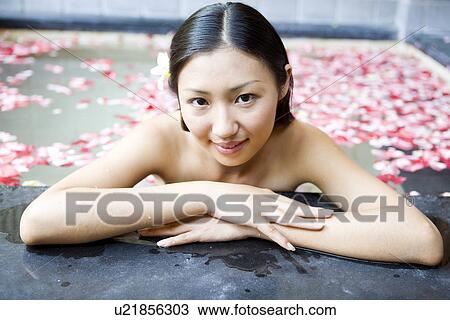 Young woman in pool with rose petals, smiling View Large Photo Image Stock Image - Young woman in pool with rose petals, smiling. Fotosearch