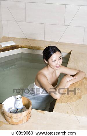 Young woman with towel, bathing in tub, elevated view View Large Photo Image Stock Image - Young woman with towel, bathing in tub, elevated view. Fotosearch