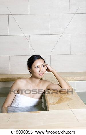 Young woman with towel, bathing in tub View Large Photo Image Stock Photography - Young woman with towel, bathing in tub. Fotosearch
