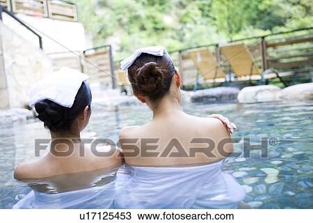 Young women with towel bathing in hot spring, rear view View Large Photo Image Stock Image - Young women with towel bathing in hot spring, rear view. Fotosearch