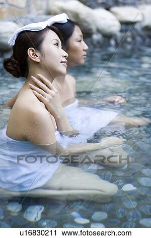 Young women with towel on head, bathing in hot spring View Large Photo Image Stock Image - Young women with towel on head, bathing in hot spring. Fotosearch