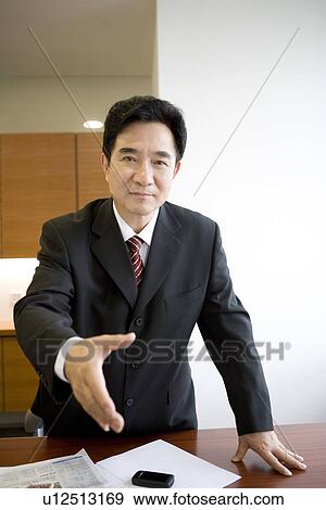 Businessman extending hand to shake View Large Photo Image Stock Photo - Businessman extending hand to shake. Fotosearch